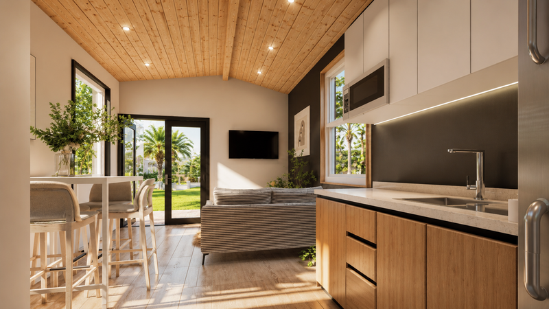 Open-plan living and kitchenette with big windows