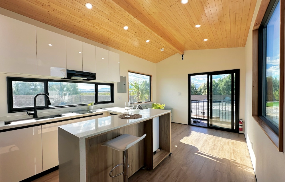 Clever interior with full-height windows, kitchen cabinetry and bar seating